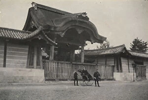 Japan: A passenger on a rickshaw being held up by two men, picture taken in front of the entrance to