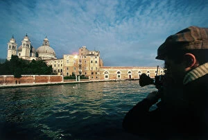Images Dated 8th October 2009: The photographer, film and television documentary maker Folco Quilici at work while filming Venice