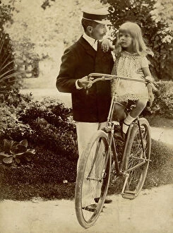 Images Dated 15th April 2010: Portrait of a man in uniform holding a baby, maybe her daughter, on a bike