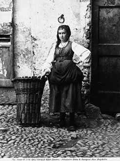 Images Dated 24th May 2011: Portrait of mountain woman with her pannier set on the ground, in the town of Fobello, in Valsesia
