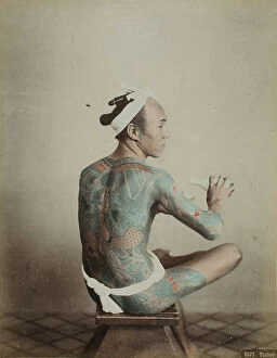 Images Dated 1st September 2011: Portrait of a seated 'Tattoo' man tattooing himself