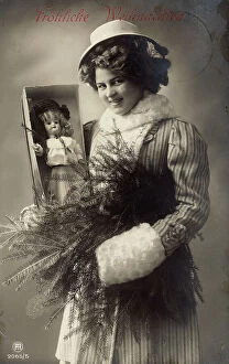Images Dated 19th September 2007: Portrait of a woman carrying a doll in a box and a branch of fir-tree, Christmas greeting post-card