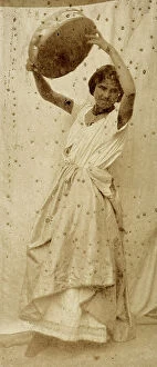 Images Dated 11th May 2011: Portrait of a young dancer raising her arms. In her hands, she holds a tambourine
