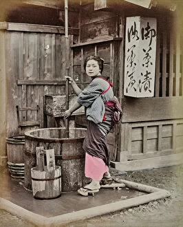 Japan: Portrait of young japanese in traditional clothes near a well