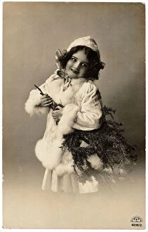 Images Dated 19th September 2007: Portrait of a young little girl carrying a fir-branch tree, Christmas greeting post-card