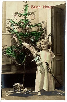 Images Dated 4th April 2012: Portrait of a young little girl with her toys near the Christmas tree, Christmas greeting post-card