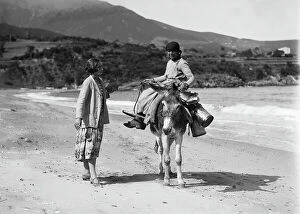 Images Dated 5th May 2009: Portrait of a young man sitting on a donkey in the island's beach Procchio, Marciana, Elba Island