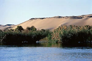 Images Dated 28th September 2011: The red sands of the desert come to the Nile