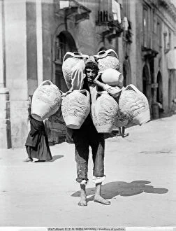 Images Dated 22nd February 2012: Seller of terracotta pots called quartare on a street in Messina