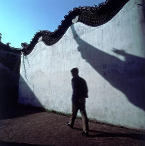 Images Dated 18th July 2008: Shanghai. Shadow games on a white scalloped wall that encloses a garden of the ancient Villas