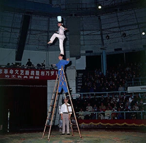 Images Dated 23rd October 2009: Shanghai. The streets. In a circus theatre a group of acrobats perform a difficult balancing act