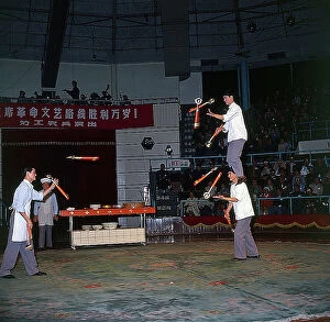 Images Dated 23rd October 2009: Shanghai. In the streets. In a circus theatre a group of acrobats perform a difficult balancing act