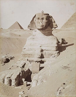 : The Sphinx and, in the background, the Great Pyramid of Cheops. Cairo, El Giza