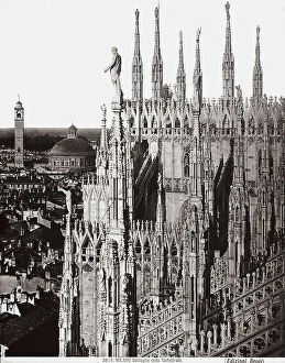 Images Dated 28th February 2008: Detail of the spires and buttresses of Milan's Cathedral with a view of the city in the background