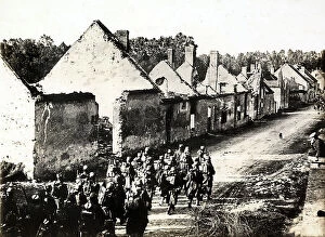 Images Dated 16th November 2011: A squad of French infantry soldiers marches on the Germans, crossing a destroyed village