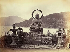 Images Dated 21st November 2011: In front of a statue of Buddha, on the shore of Lake Hokomi, two praying believers