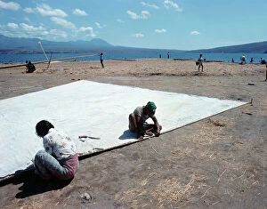 Images Dated 11th July 2011: Sunda Islands, Sumbawa Island, Fishermen repairing a sail