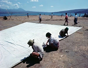 Images Dated 11th July 2011: Sunda Islands, Sumbawa Island, Fishermen repairing a sail
