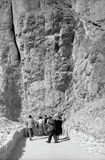 Images Dated 8th September 2011: Tourists stroll between cliffs, Thebes (ancient Luxor)
