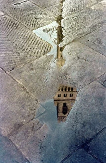 Florence Collection: Tower (Tower of Arnolfo) of the Palazzo Vecchio in Florence reflected in a puddle