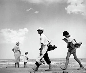 Images Dated 4th August 2010: Two travelling salesmen walking on a beach