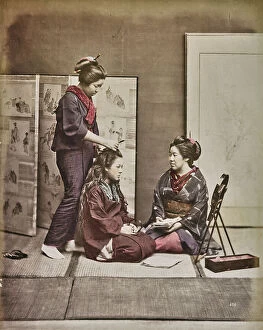 Japan: A woman combs her hair and prepares the hairstyle of another woman, Japan