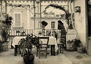 Images Dated 26th May 2011: A woman looking out onto the terrace of a restaurant. Postcard sent by the photographer to
