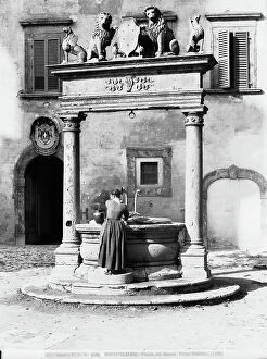 Images Dated 15th November 2011: A woman at the well of the Piazza del Duomo in Montepulciano, Siena