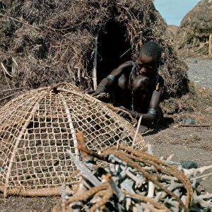 Images Dated 6th July 2009: Woman of Turkana ethnicity fixing a fishing net, Island of Lake Turkana