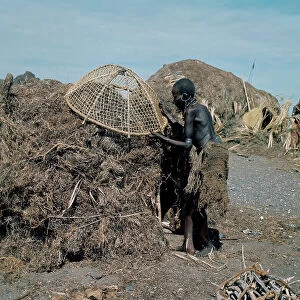 Images Dated 6th July 2009: Woman of Turkana ethnicity with the traditional mesh loincloth and deformed legs due to diet
