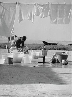 Images Dated 8th March 2010: Woman washing laundry in the open air