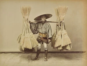 Japan: Young Japanese who carries a shoulder of sorghum brooms