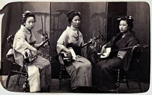 Images Dated 23rd November 2011: Three young Japanese woman playing a traditional instrument
