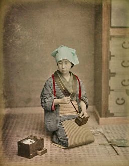 Japan: Young japanese woman portraying while preparing a Kiseru (pipe)