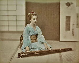 Japan: Young japanese woman in traditional dress with a musical instrument