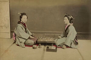 Images Dated 4th August 2011: Two young Japanese women playing a game