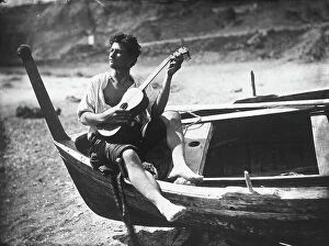 Images Dated 22nd November 2007: Young man playing guitar on a boat