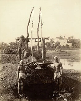 Images Dated 4th March 2010: Two young Nubian farmers posing in front of a rudimental irrigation machine in the fields of