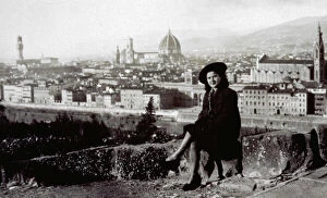 Florence Collection: Young woman seated with the panorama of the city of Florence behind her