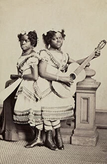 Images Dated 4th May 2011: Two young women of color photographed with a guitar