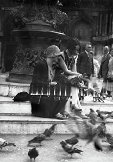 Images Dated 23rd June 2009: Young women playing with pigeons in Piazza San Marco, Venice